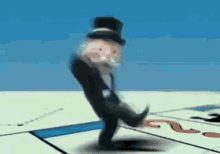 a monopoly man is standing on a board with his foot on the board .