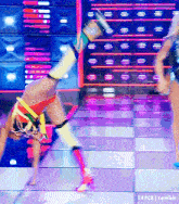 a woman with a prosthetic leg is doing a handstand on the floor