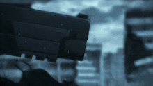 a blurred image of a person holding a gun with the letter u on it