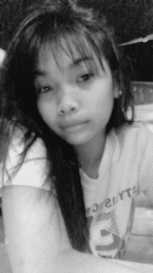 a black and white photo of a young girl wearing a t-shirt that says ' o'reilly ' on it