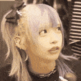 a girl with a bow in her hair looks up at something