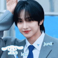 a boy in a suit and tie with the name junil on the bottom right