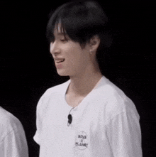 a man wearing a white shirt that says boys planet