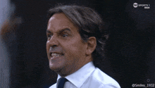 a man in a white shirt and tie is on a sports 1 live channel