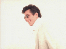 a close up of a person 's face with glasses on