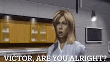 a woman in a white shirt is talking to victor