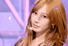 a woman with blonde hair is wearing a microphone