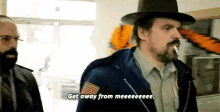 a man with a beard is smoking a cigarette and saying get away from meeeee