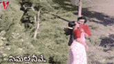 a man and a woman are kissing in a field with a watermark that says ' v videos ' on it