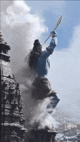 a statue of a man with a trident in his hand