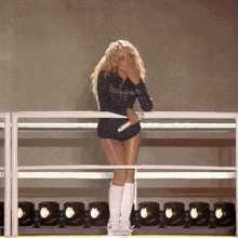 a woman standing on a stage with a microphone in her hand