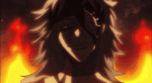 a close up of a person 's face with flames behind it
