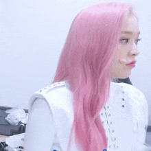 a woman with pink hair and a white jacket