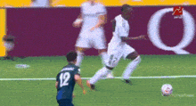 a soccer player with the number 12 on his jersey is kicking the ball