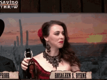 a woman in a red dress holds a bottle in front of a sign that says rosaleen s. byrne on it