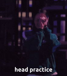 a woman in a green sweatshirt is covering her face with her hands and the words head practice are below her