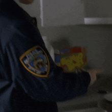 a man in a blue jacket with a patch that says police department on it