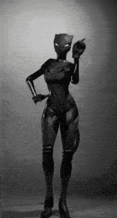 a black and white photo of a woman in a black cat suit