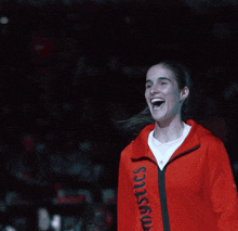 a woman in a red jacket that says mystics on it