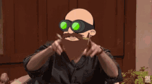 a man with a beard wearing goggles says bye bye in yellow letters