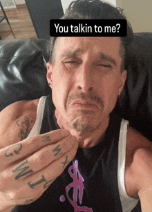 a man laying on a couch with a sticker that says you talkin to me on it