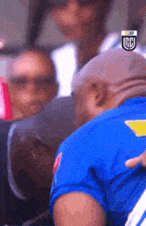 a blurry picture of a man in a blue shirt with a logo that says rcb