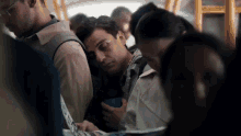 a man is sleeping on a bus while another man looks at a map
