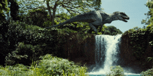 a dinosaur is jumping over a waterfall in a jungle