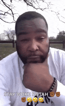 a man with a beard is making a funny face and says stay woke sitah