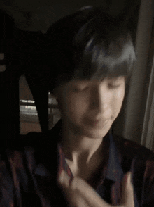 a close up of a person 's face with their hands on their face