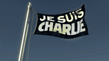a black flag that says je suis charlie