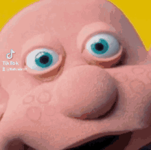 a close up of a cartoon character 's face with blue eyes and a big nose .