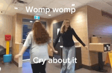 two women are dancing in a restaurant and one of them is crying about it .