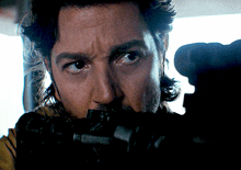 a close up of a man 's face with a black object in his mouth