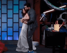 a man and woman are dancing on a stage .