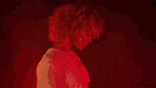 a woman with curly hair is wearing a white t-shirt that says i 'm always