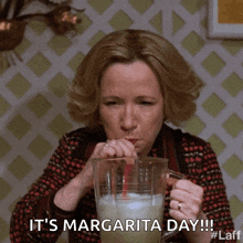 a woman is drinking a margarita through a straw and the caption says it 's margarita day