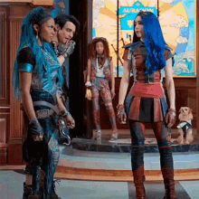 a group of people are standing in front of a sign that says aura
