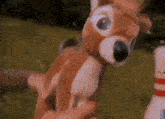 a person is holding a stuffed animal that looks like a deer .