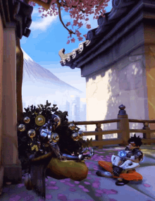 a video game character is laying on the ground in front of a building with a mountain in the background