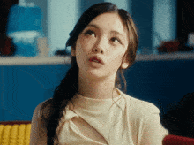 a woman in a yellow top is looking up
