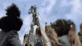 a group of people standing around a statue with the words 4-u 4-u 4-u 4-u