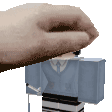 a close up of a person 's hand holding a block .