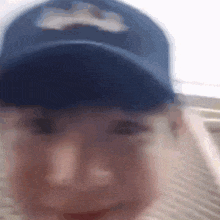 a blurry picture of a man wearing a blue hat
