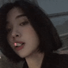 a woman with short hair is smoking a cigarette in a car .