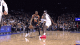 a basketball player with the number 35 on his jersey dribbles the ball