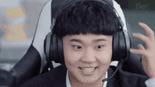 a man wearing headphones and a microphone with the word hebil in the corner