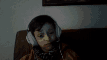 a young boy wearing headphones with the words xd written above him