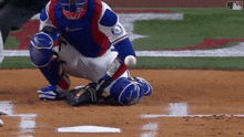 a baseball player with the word phillies on his jersey kneeling on the ground