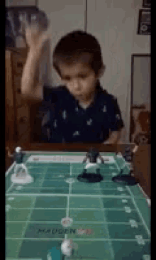a young boy is playing a game of madden